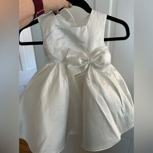 Flower girl dress white with bow in back and front worn for an hour.